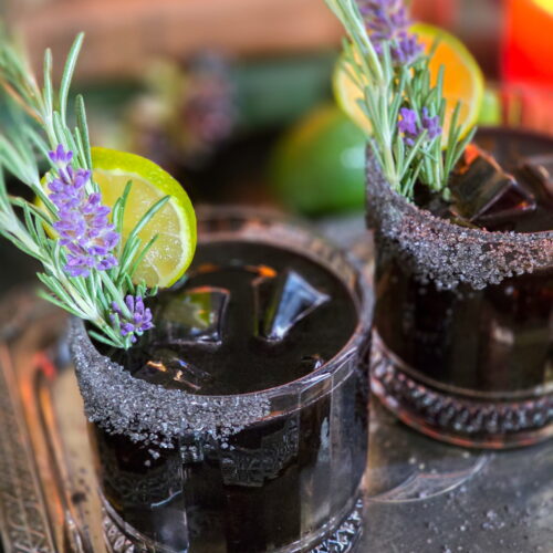 black magic margarita with rosemary lime lavender garnish