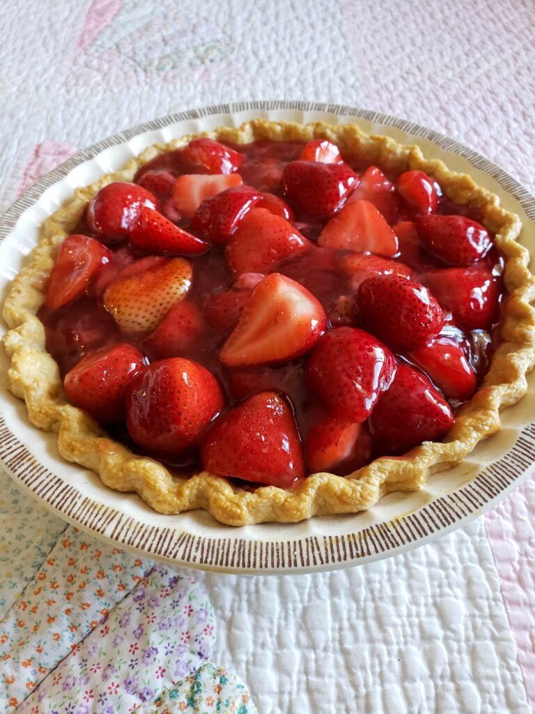 fresh strawberry pie on quilt