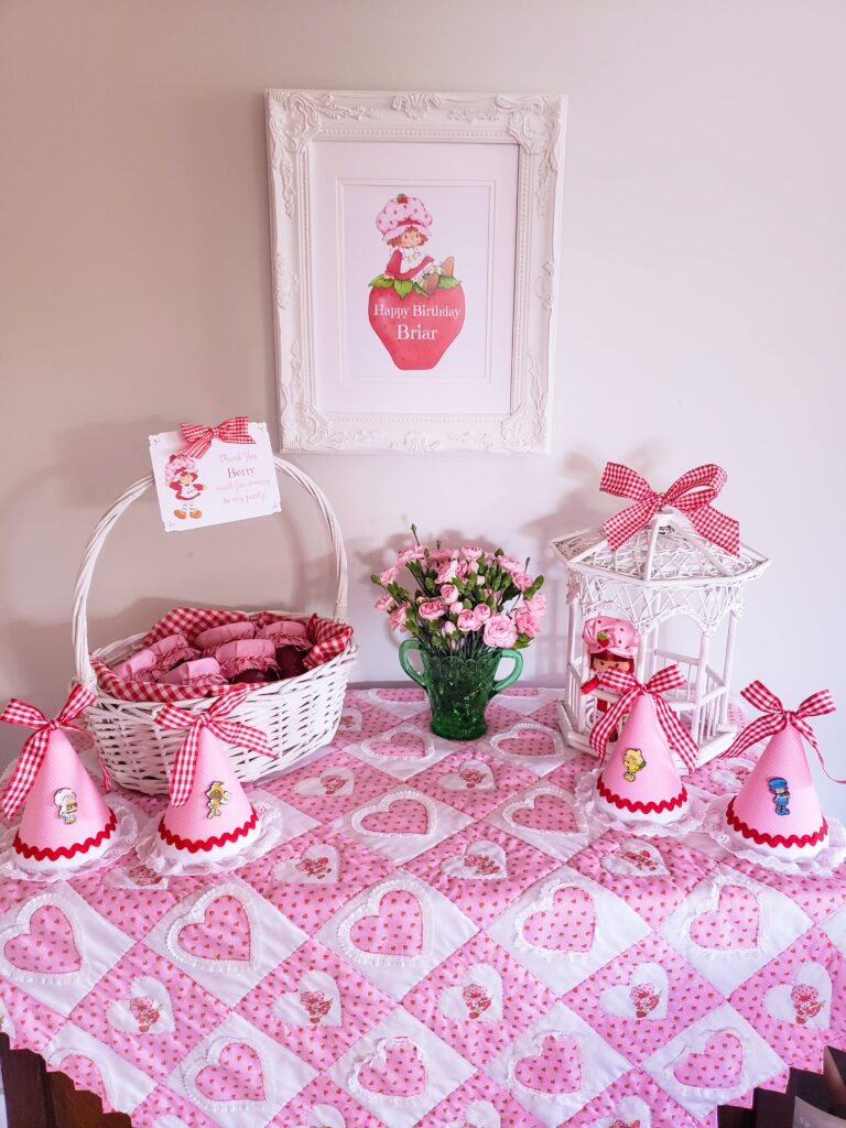 strawberry shortcake favor table with jam favors, gazebo and party hats