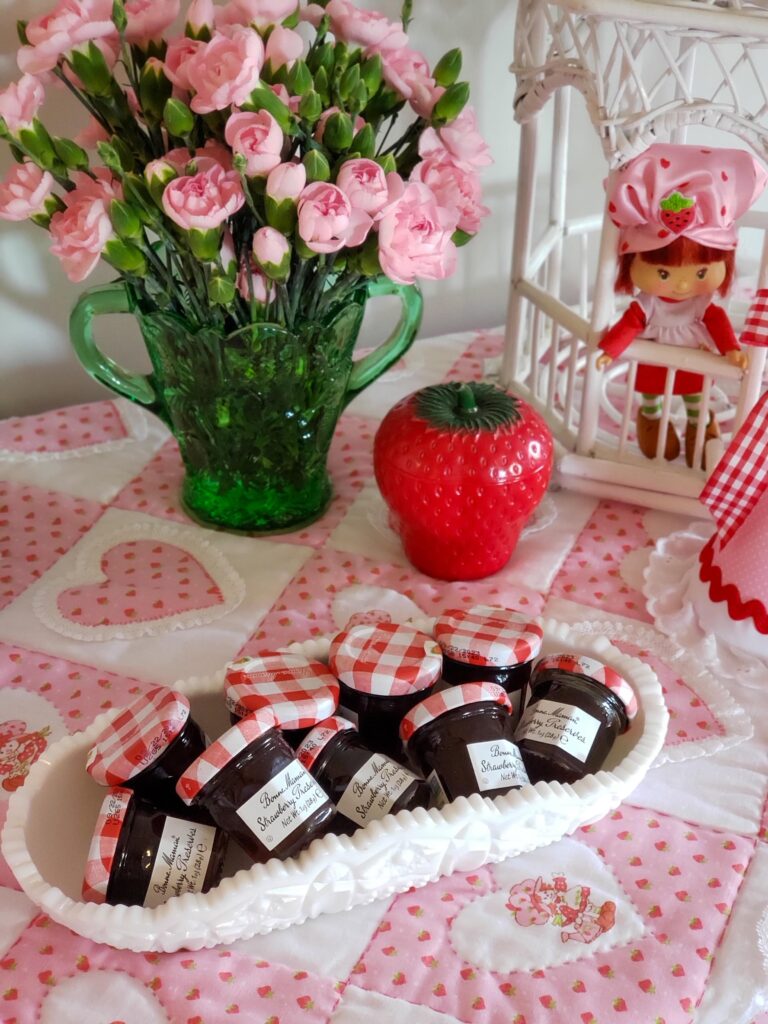 strawberry shortcake favor table with jam favors, gazebo and doll