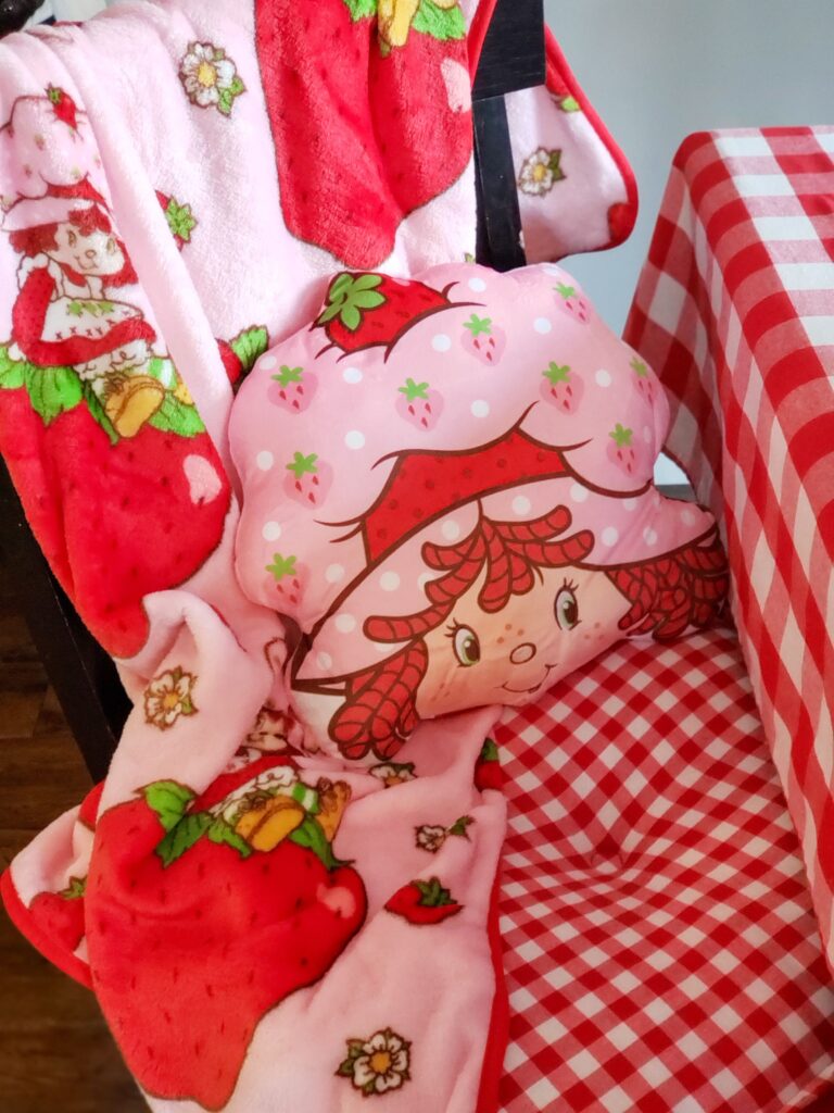 strawberry shortcake blanket and pillow on a chair