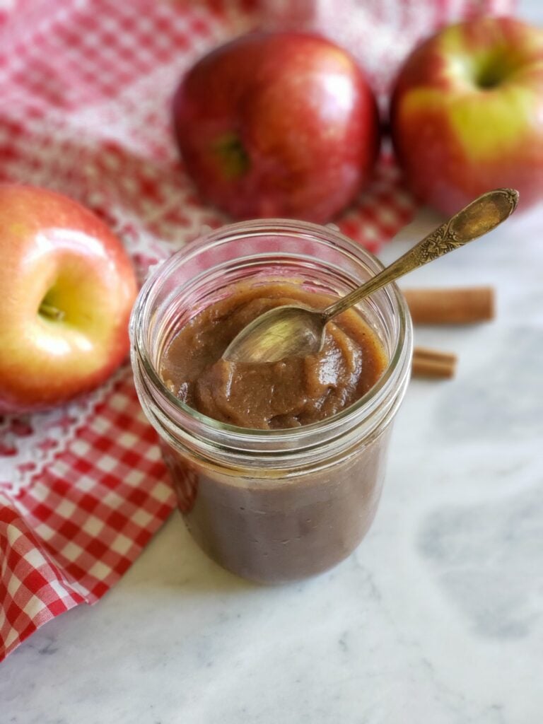 old fashioned apple butter in a jar with spoon