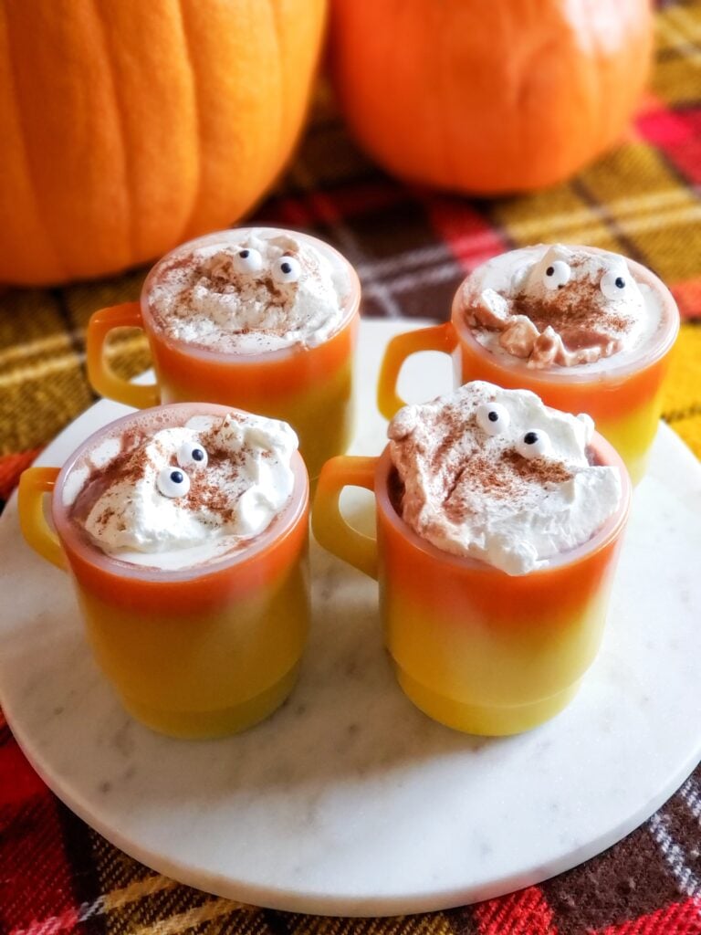 halloween hot chocolate with whipped cream candy eyeballs in a vintage mug