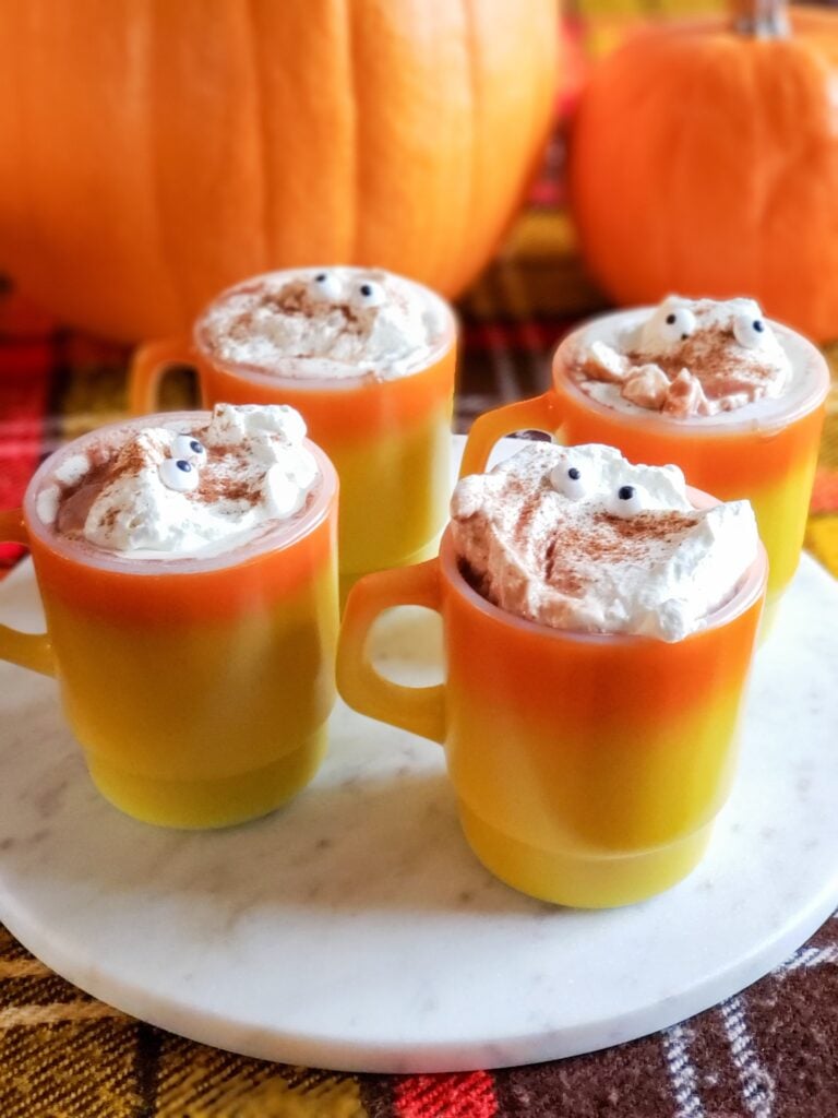 halloween hot chocolate with whipped cream candy eyeballs in a vintage mug