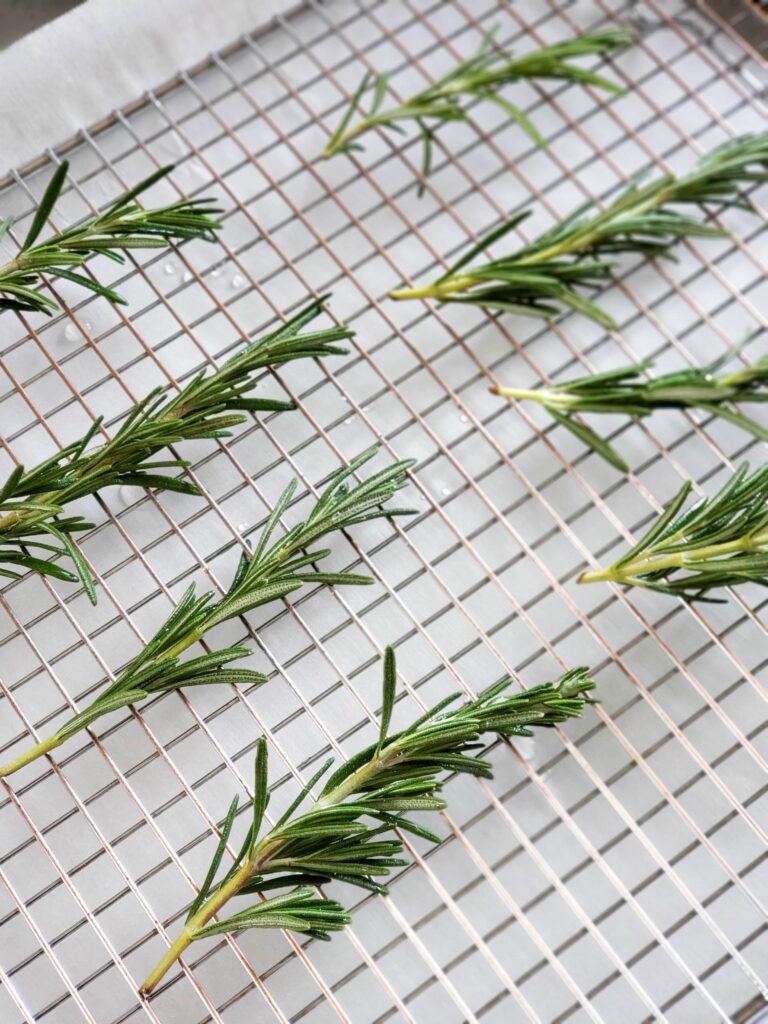 sugared rosemary on a wire rack