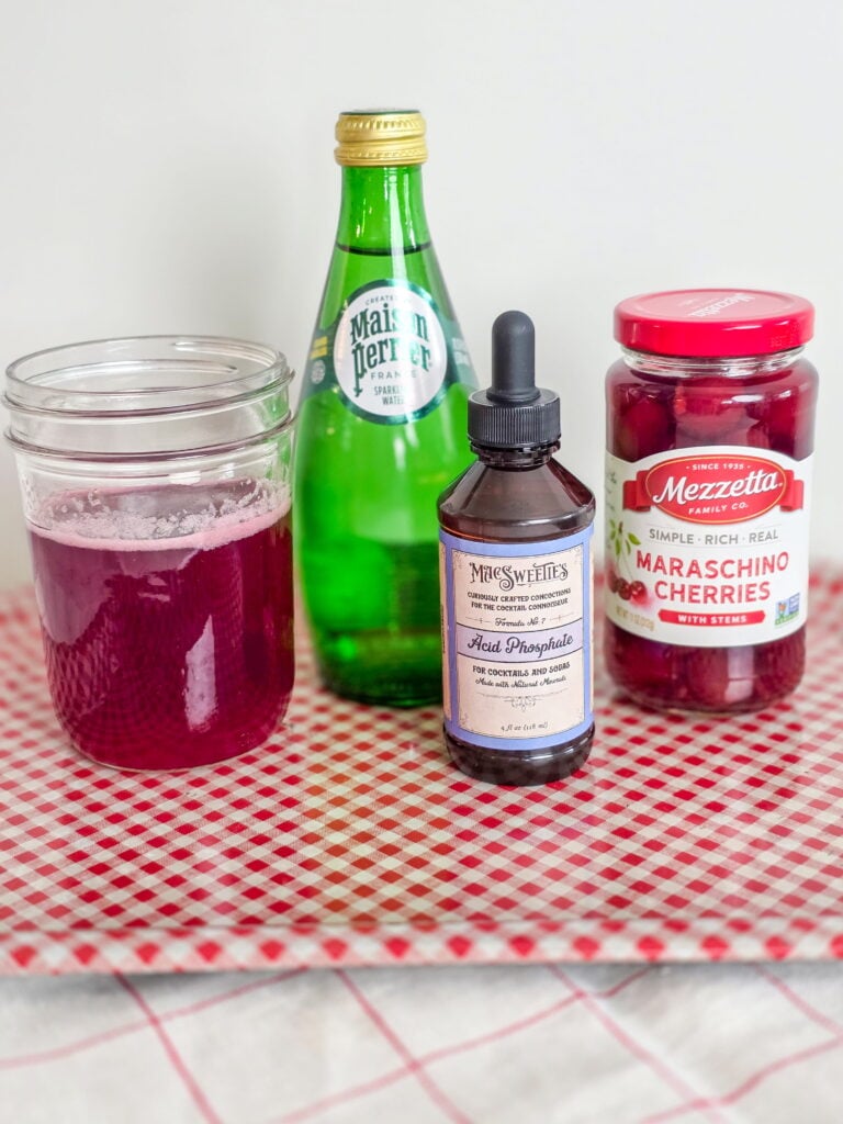 old-fashioned cherry phosphate ingredients on a gingham tray
