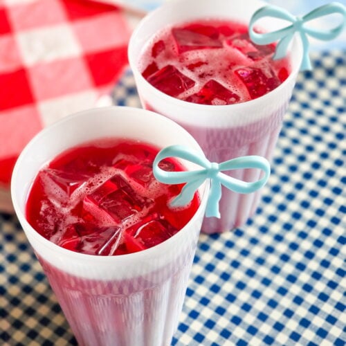 red devil cocktail-cape codder on gingham tray with red and white gingham napkins and blue bow drink charm
