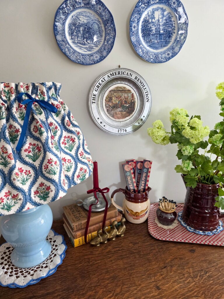 Vintage Cottage 4th of July Decor Ideas with Americana Charm featuring vintage crocks, baskets, gingham, and flowers