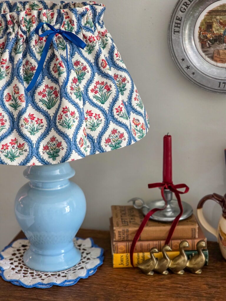 Vintage Cottage 4th of July Decor Ideas with Americana Charm featuring vintage crocks, baskets, gingham, and flowers