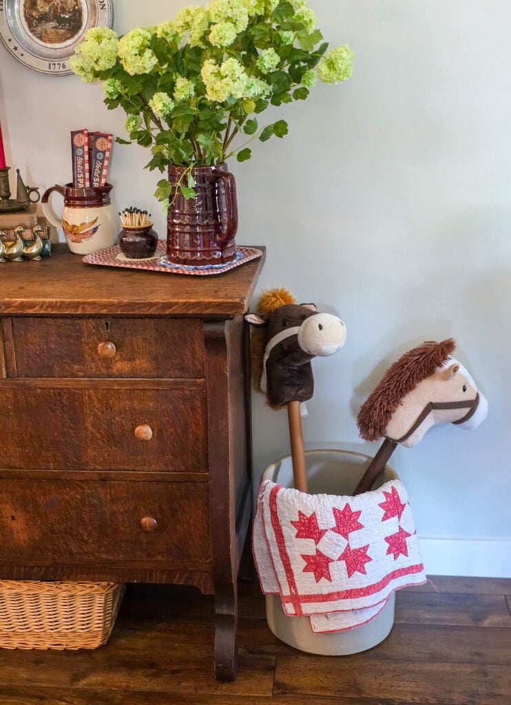 Vintage Cottage 4th of July Decor Ideas with Americana Charm featuring vintage crocks, baskets, gingham, and flowers
