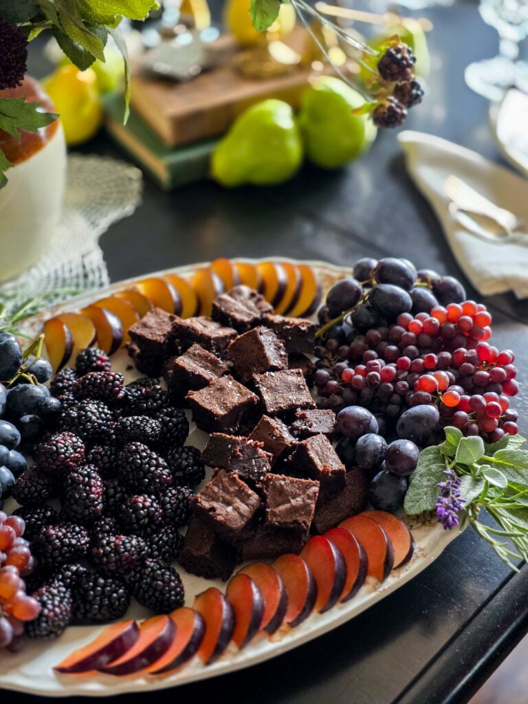 owens harvest fruit and dessert snack board with brownies and dark fruit and herbs